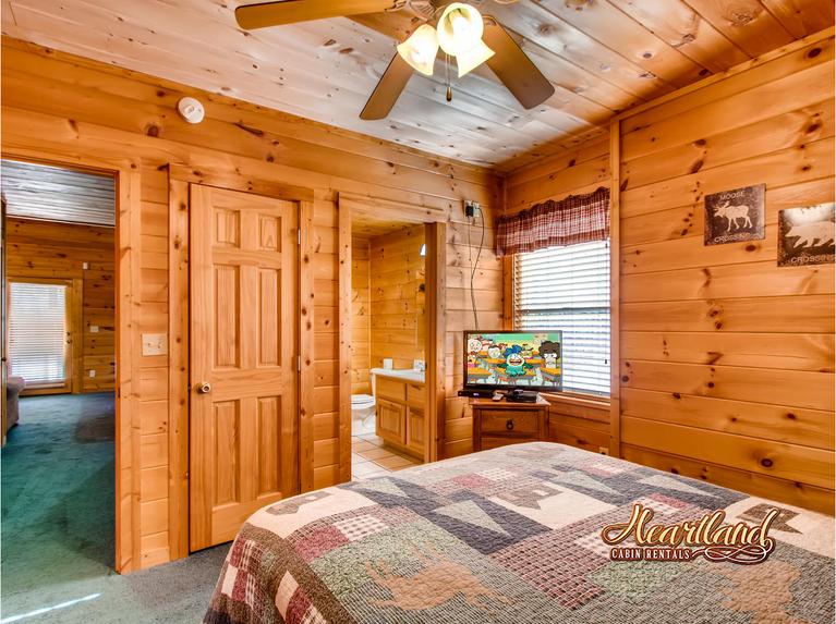 Bedroom with flat screen TV and adjoining bathroom